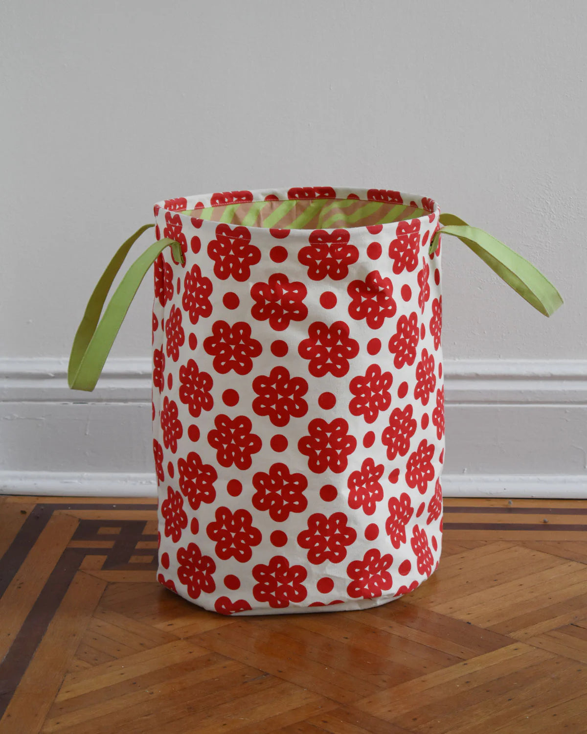Fabric basket with red floral pattern on a wooden floor